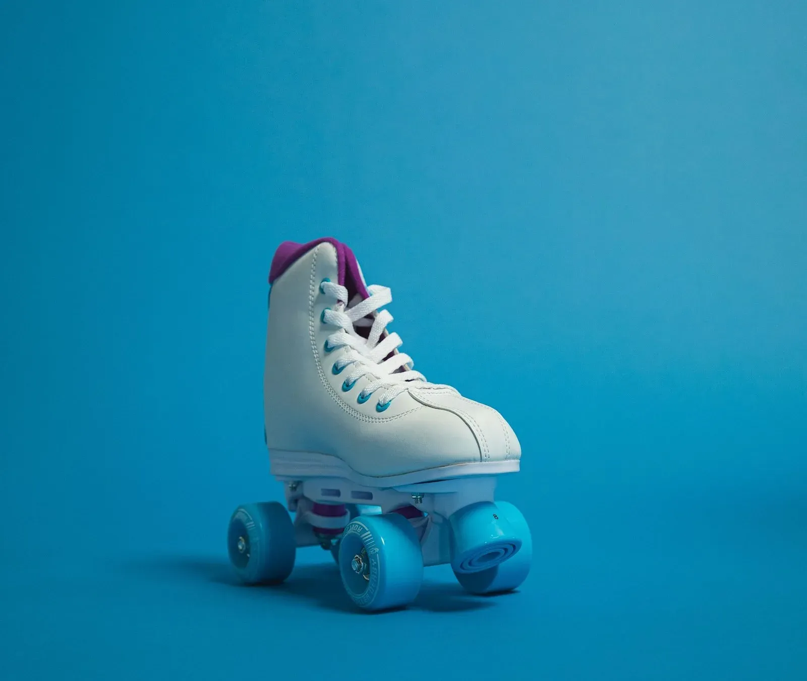 A white and blue roller skate